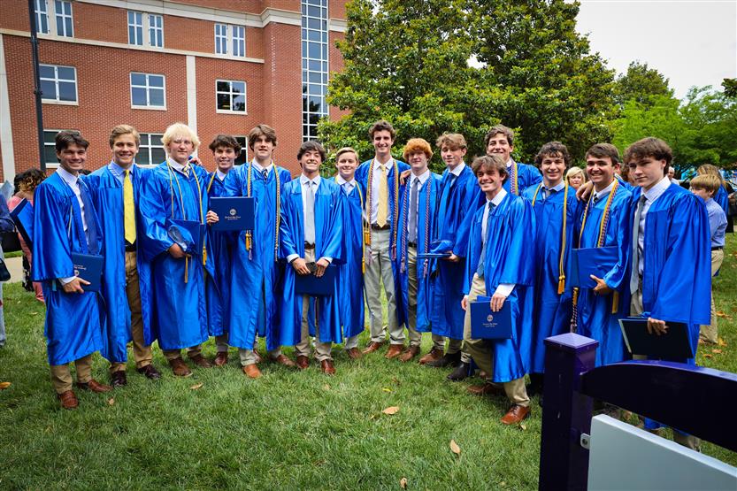 A group of graduates wearing blue robes